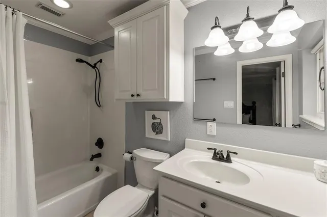 a bathroom with a sink vanity mirror and shower