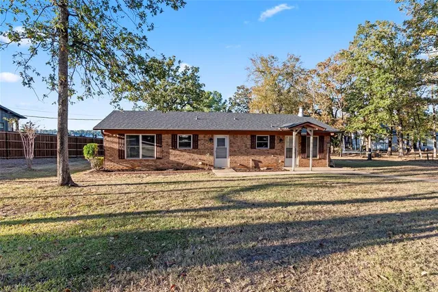 a view of dirt yard with a large tree