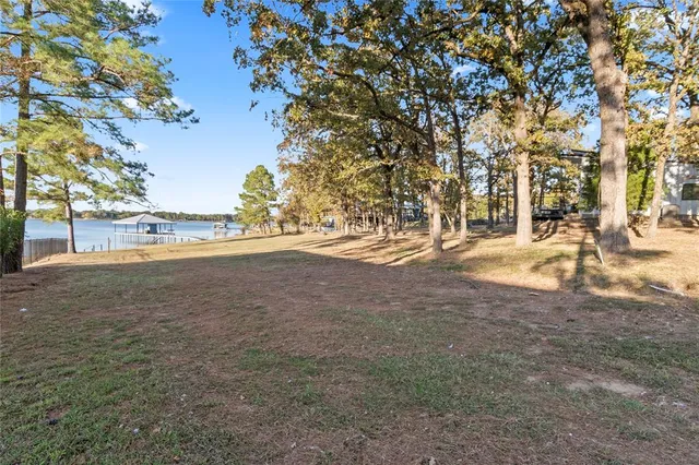 a view of a house with a yard and tree