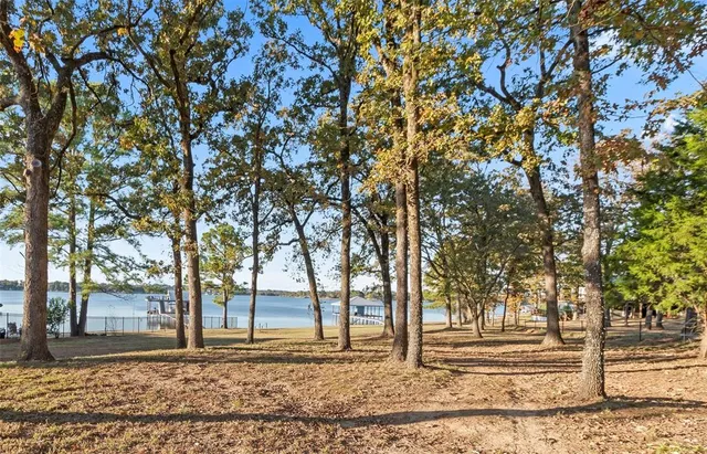 a bedroom with a bed and large windows