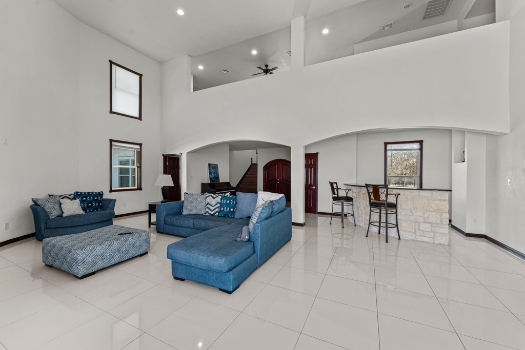 1206 Walter Hoffman Road Cedar Creek, TX 78612 - Photo 18 of 40 a living room with furniture and a dining table with kitchen view