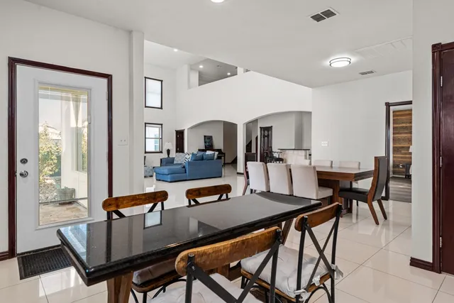 a bedroom with a bed and a flat tv screen on dresser