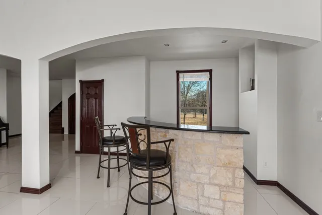 a living room with furniture and a ceiling fan