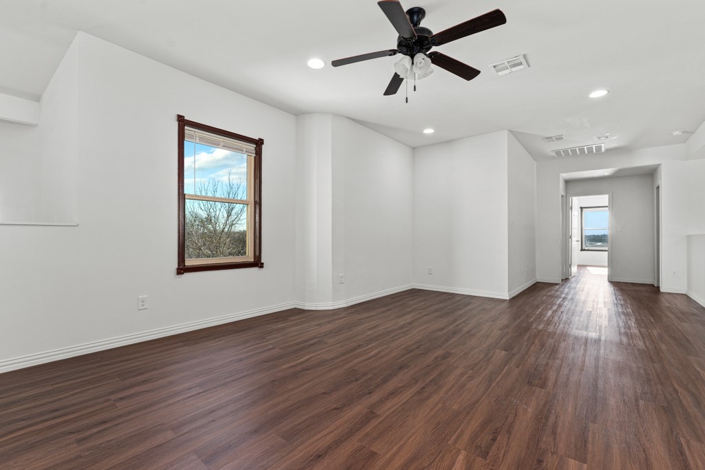 1206 Walter Hoffman Road Cedar Creek, TX 78612 - Photo 26 of 40 a view of empty room with wooden floor and fan