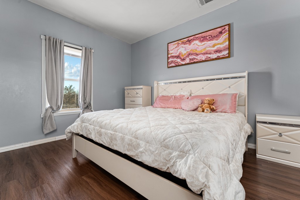 1206 Walter Hoffman Road Cedar Creek, TX 78612 - Photo 30 of 40 a large bed sitting in a bedroom next to a window