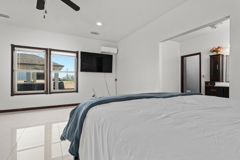 1206 Walter Hoffman Road Cedar Creek, TX 78612 - Photo 35 of 40 a bedroom with a bed and a flat screen tv