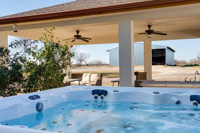a living room with furniture and a dining table with kitchen view