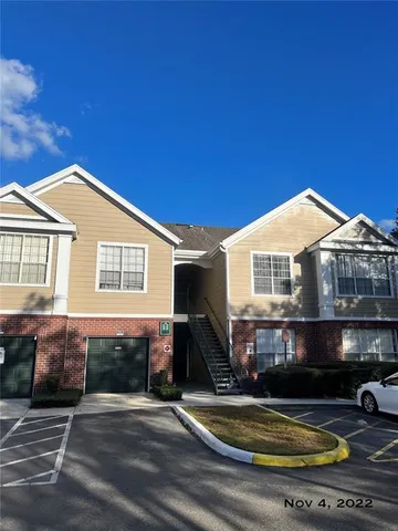 a view of a house with swimming pool and sitting area