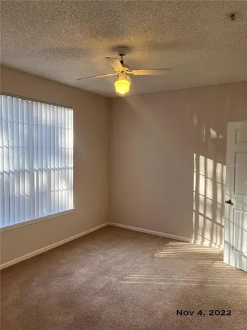 an empty room with a ceiling fan and closet
