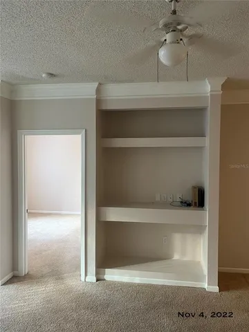 a view of empty room with a fan