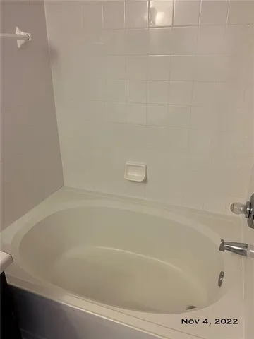 a white toilet sitting next to a shower