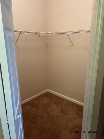 a view of a tennis ground with large trees