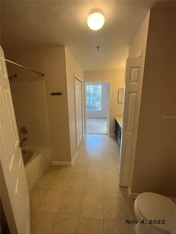 a white toilet sitting next to a shower