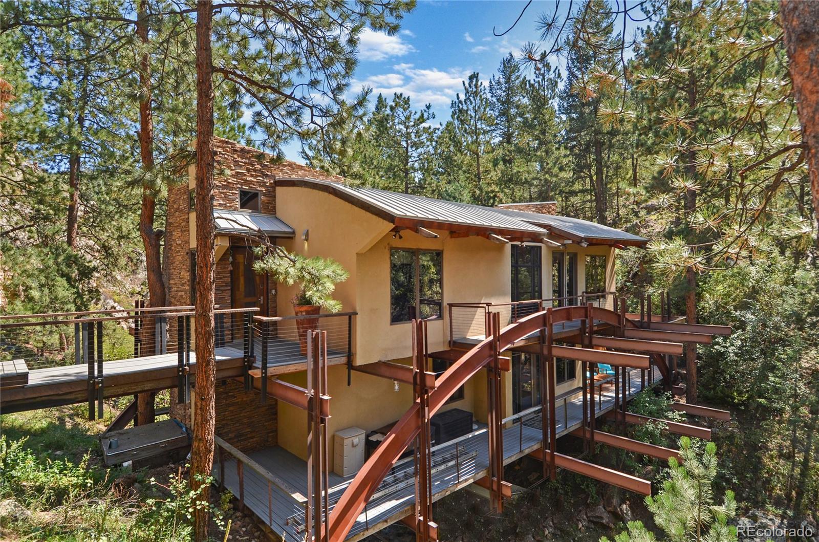 3074 High Road Evergreen, CO 80439 - Photo 1 of 40 a view of house with roof deck and furniture