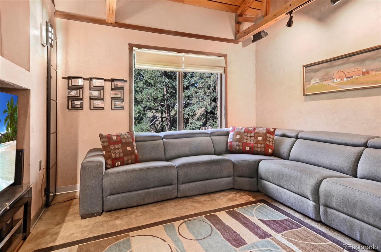 3074 High Road Evergreen, CO 80439 - Photo 12 of 40 a living room with furniture and a large window