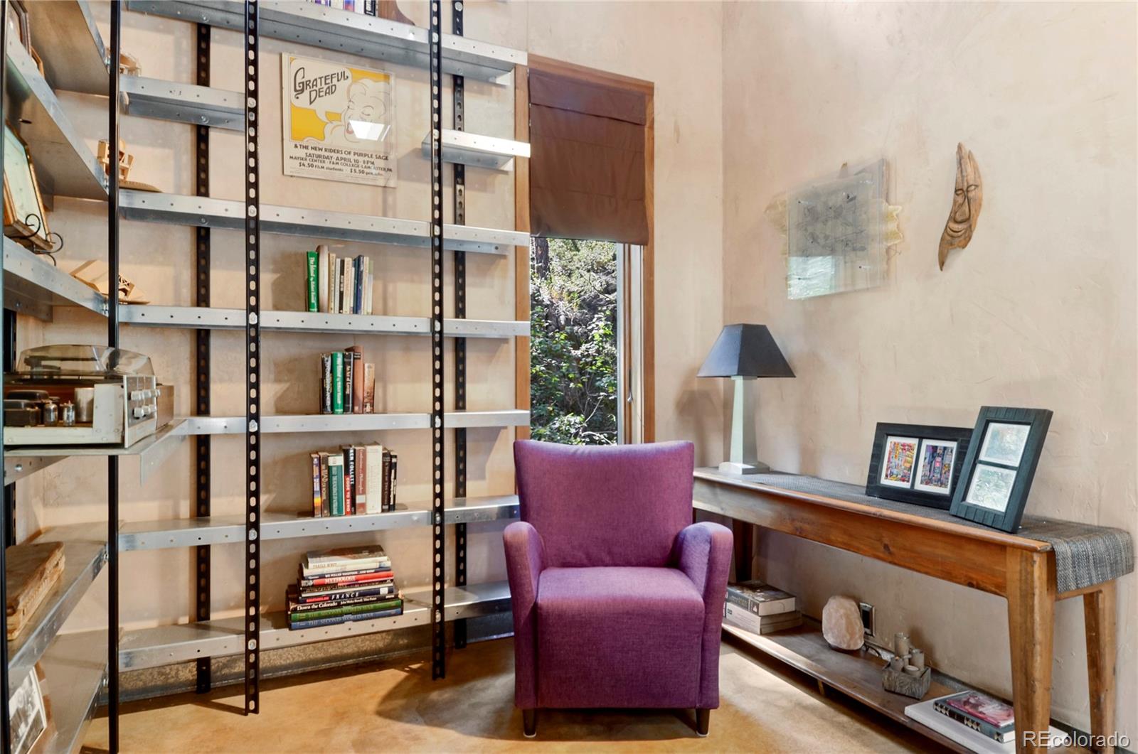 3074 High Road Evergreen, CO 80439 - Photo 13 of 40 a living room with furniture and a book shelf