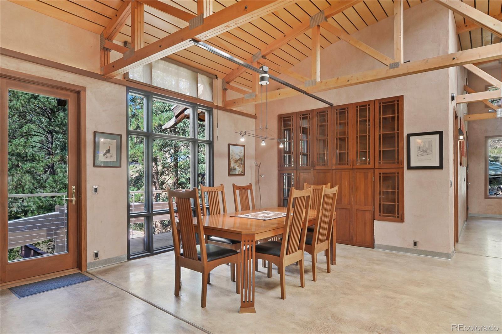3074 High Road Evergreen, CO 80439 - Photo 17 of 40 a view of an outdoor dining space with a flat tv screen