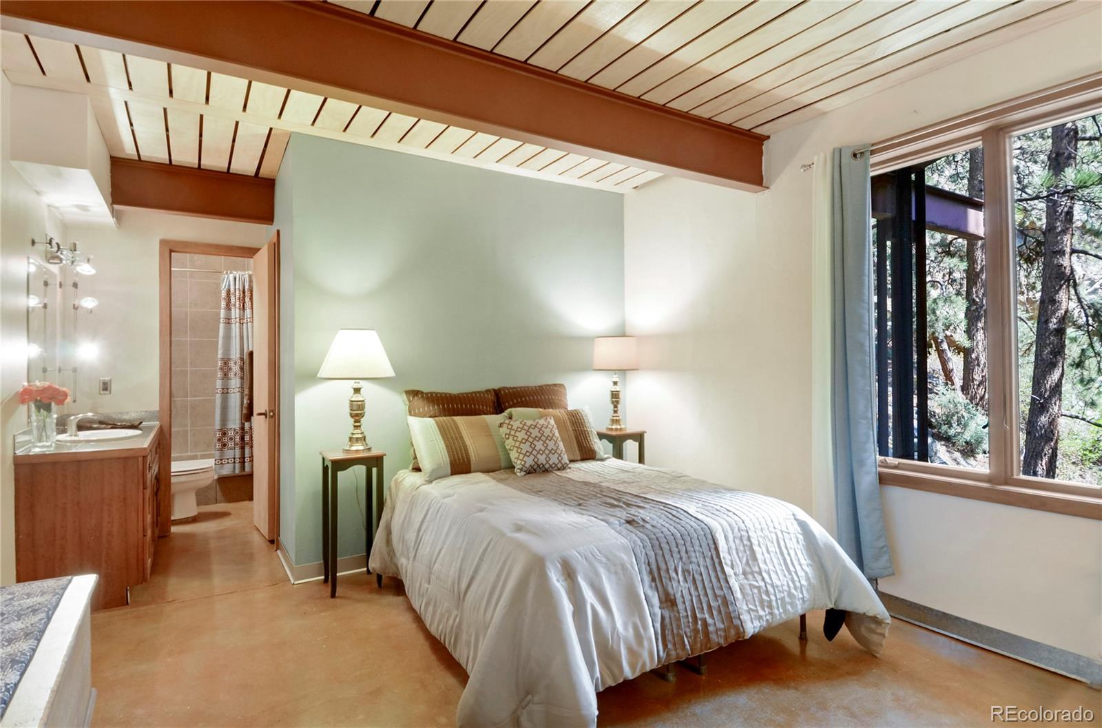 3074 High Road Evergreen, CO 80439 - Photo 18 of 40 a bed room with a bed and a large window