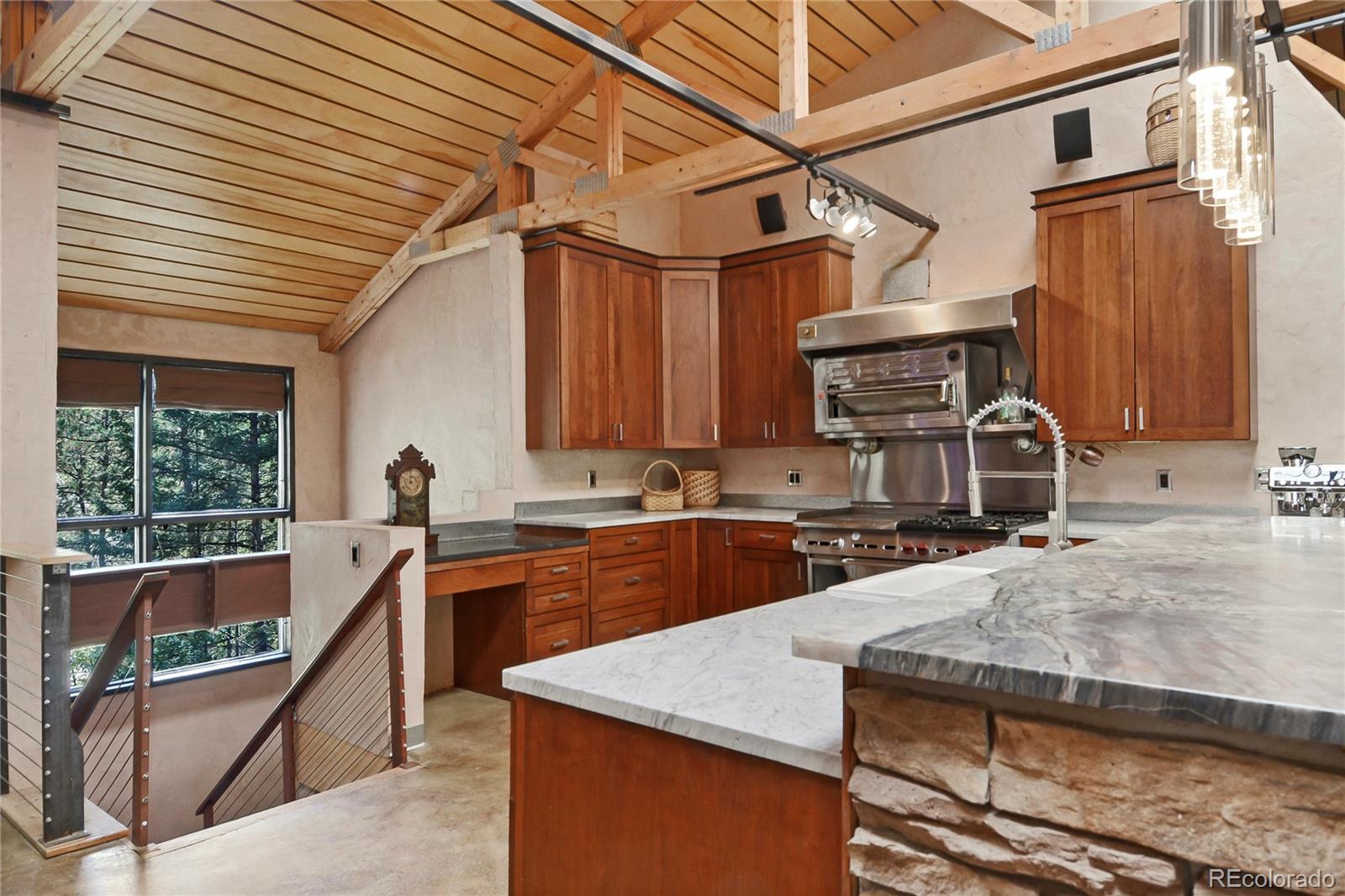 3074 High Road Evergreen, CO 80439 - Photo 19 of 40 a kitchen with a stove a sink and a refrigerator