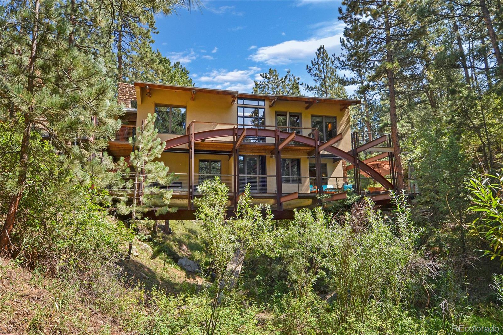 3074 High Road Evergreen, CO 80439 - Photo 2 of 40 an aerial view of a house with swimming pool and garden