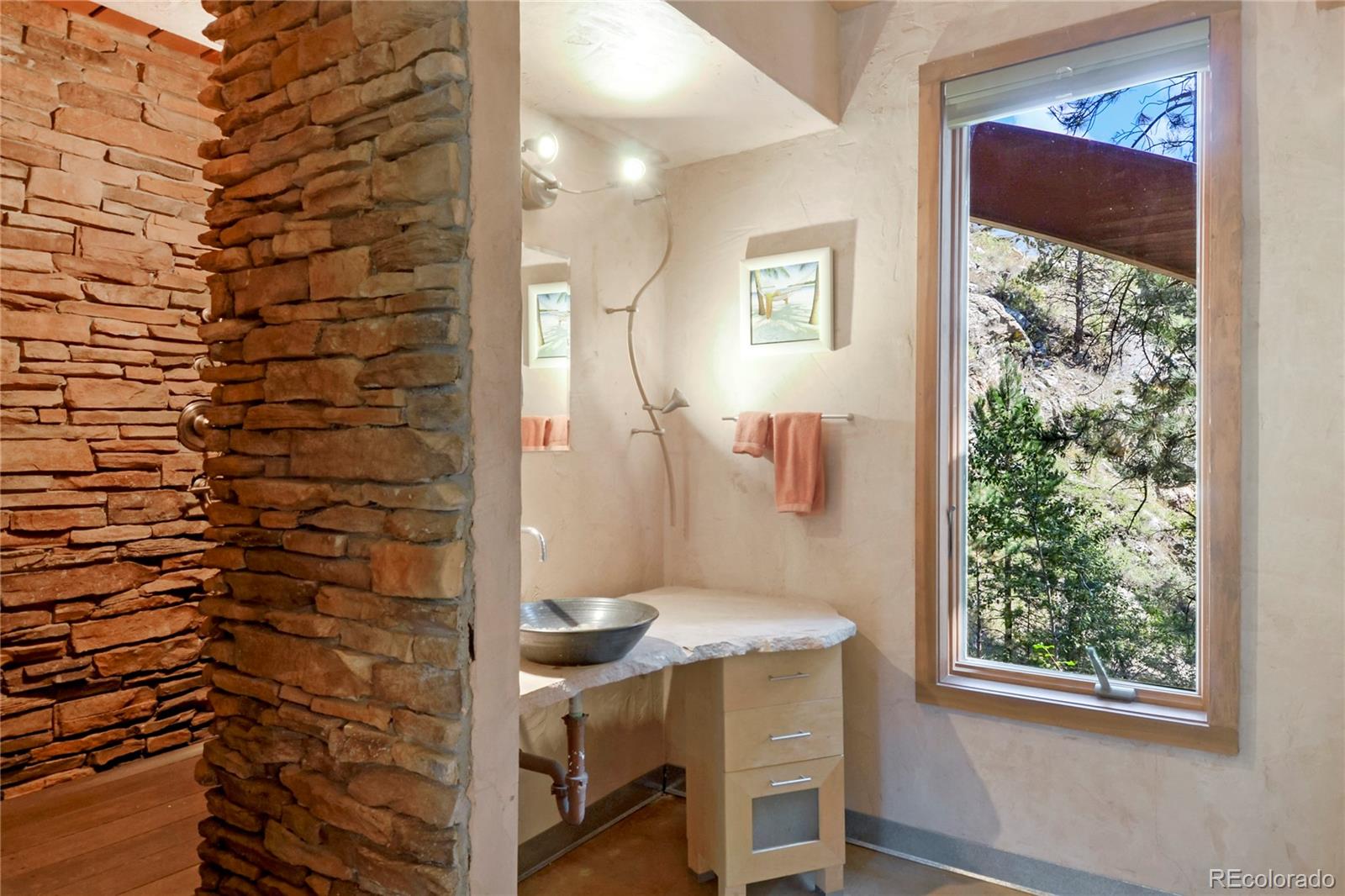3074 High Road Evergreen, CO 80439 - Photo 24 of 40 a bathroom with a sink and a mirror