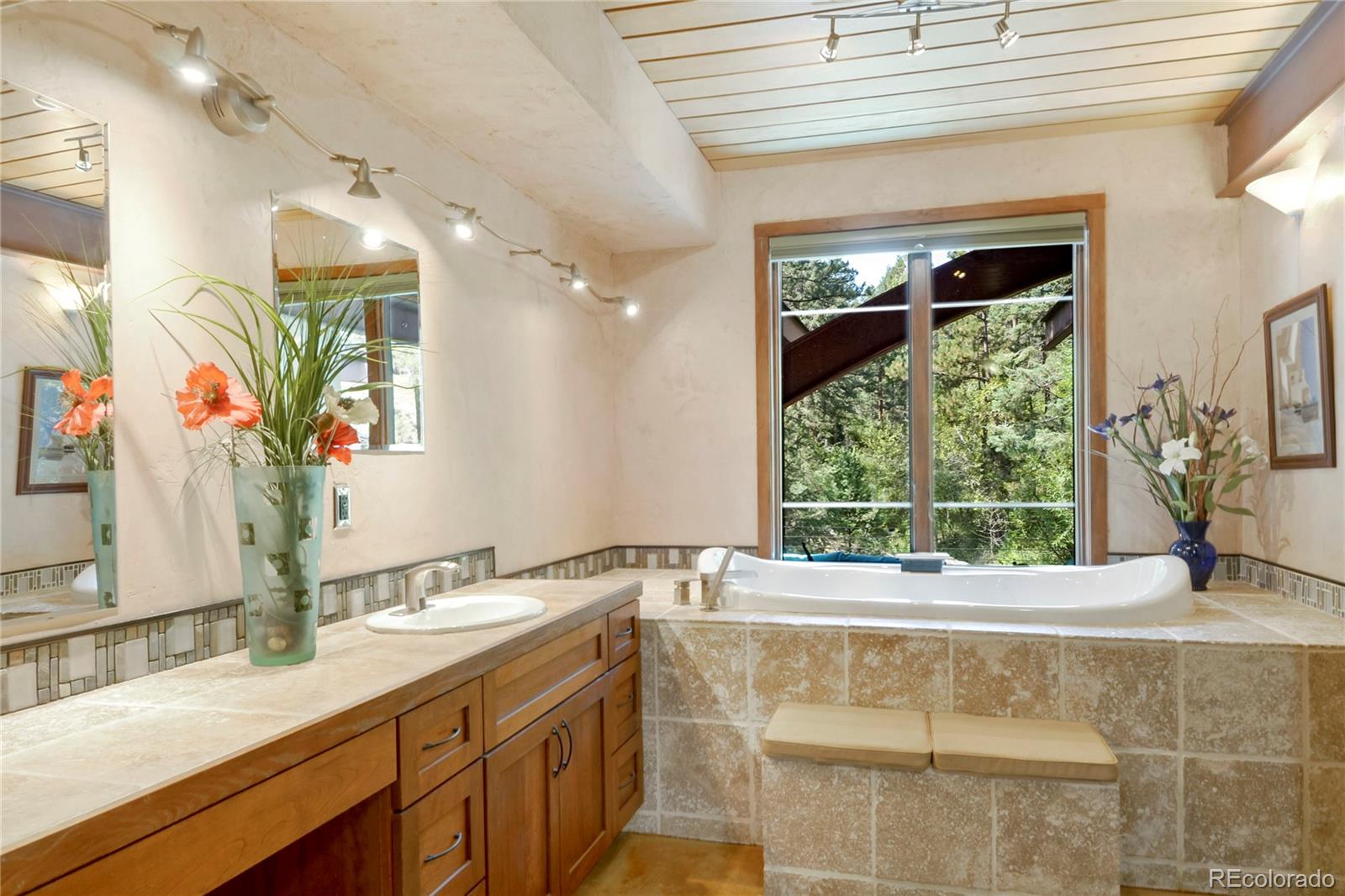 3074 High Road Evergreen, CO 80439 - Photo 25 of 40 a bathroom with a granite countertop sink and a large mirror