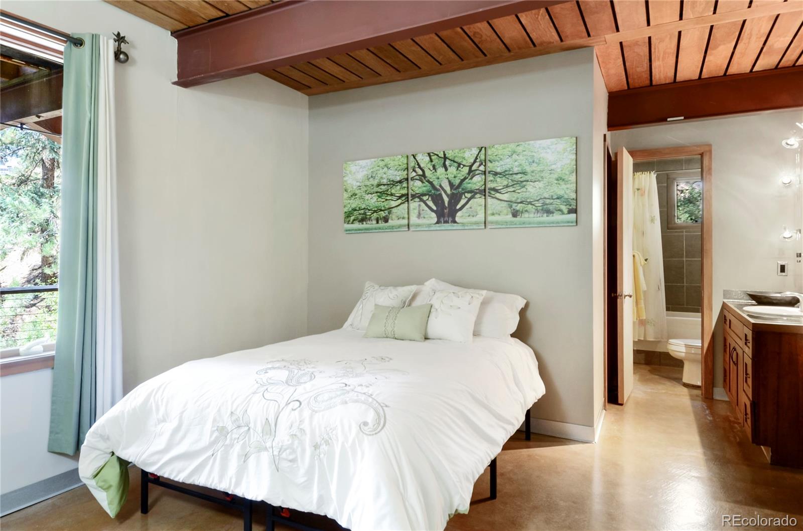 3074 High Road Evergreen, CO 80439 - Photo 26 of 40 a bed sitting in a bedroom next to a window