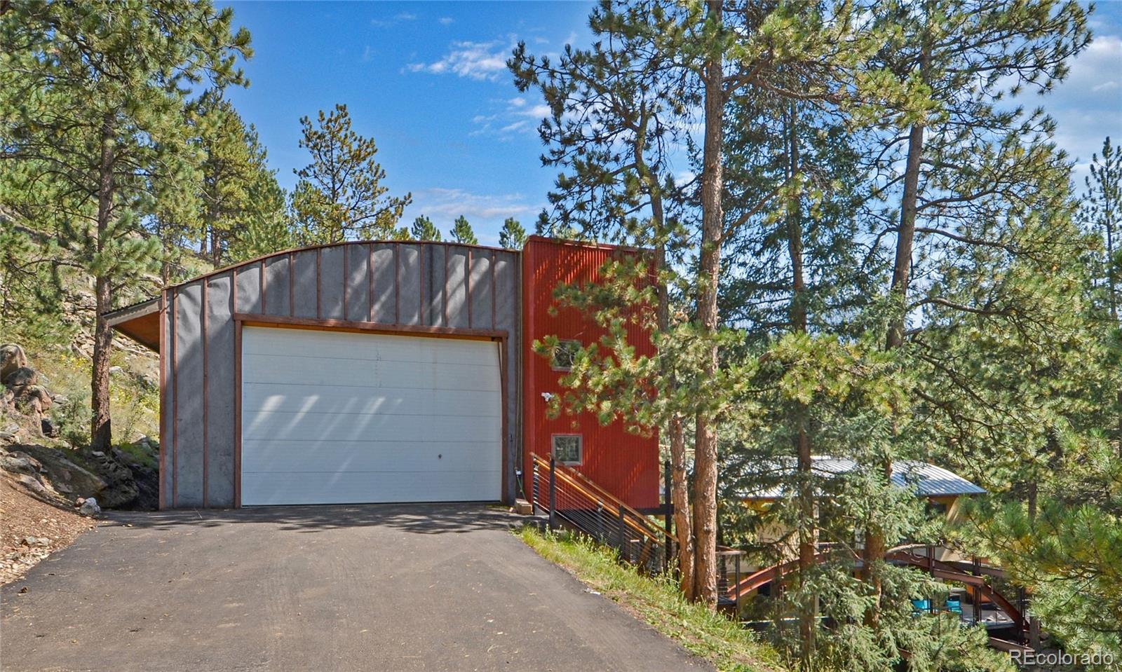 3074 High Road Evergreen, CO 80439 - Photo 28 of 40 a wooden door with tree in front of it