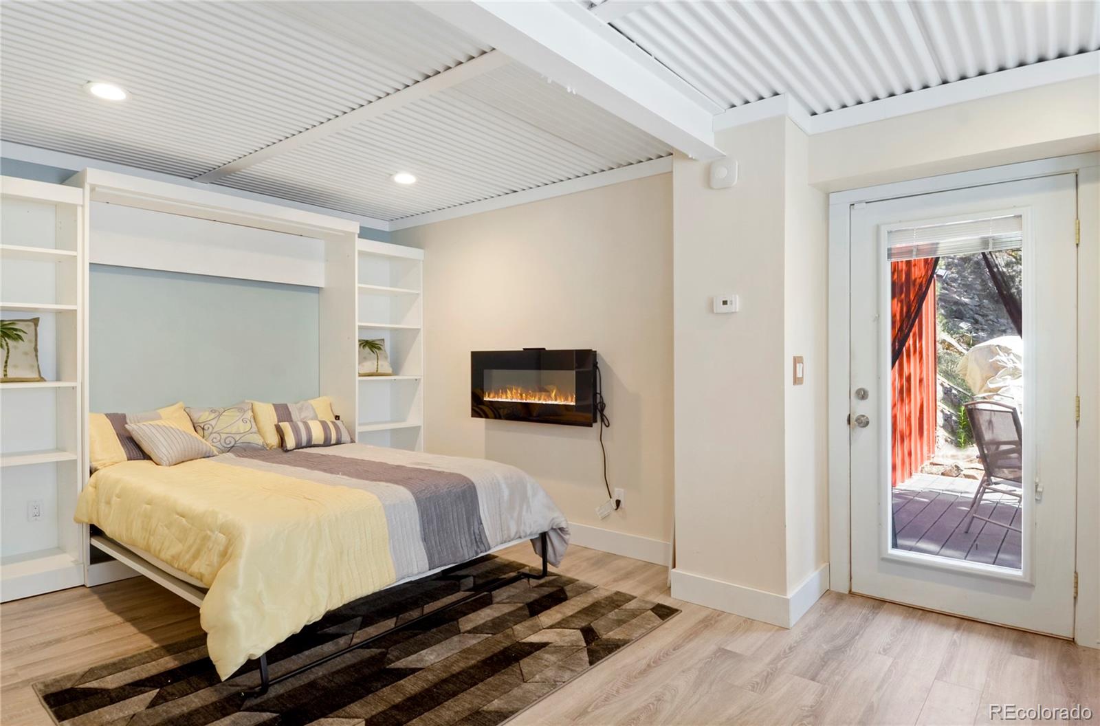 3074 High Road Evergreen, CO 80439 - Photo 31 of 40 a bedroom with a bed and a painting on the wall
