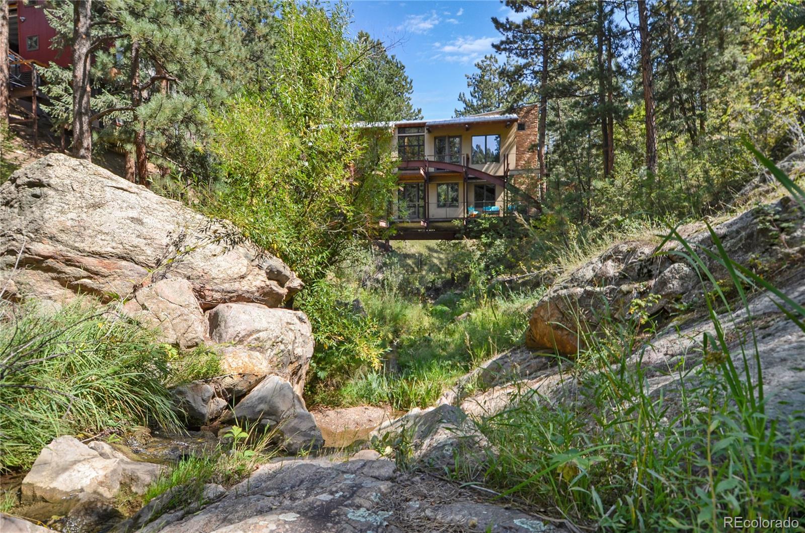 3074 High Road Evergreen, CO 80439 - Photo 33 of 40 a view of a house with a yard