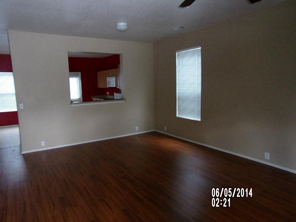 23823 Single Oak Street Spring, TX 77373 - Photo 4 of 10 a view of an empty room with wooden floor and a window