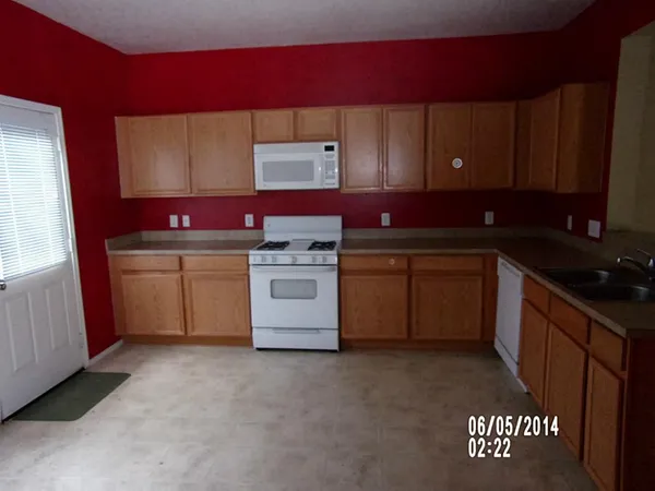 a kitchen with a sink stove and cabinets