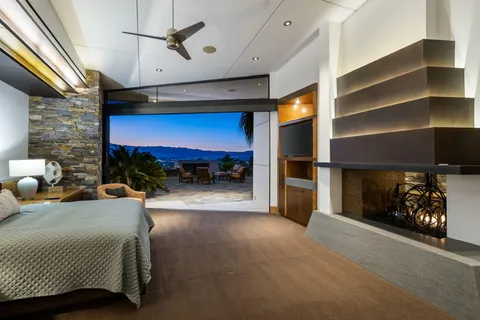 a bedroom with furniture and a fireplace