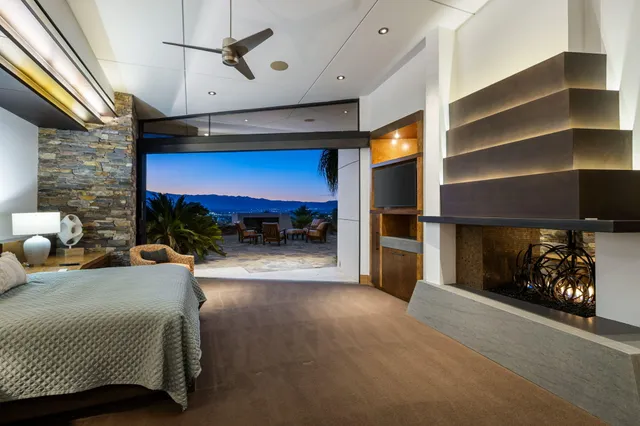 a bedroom with furniture and a fireplace