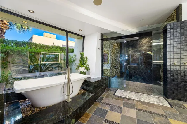 a bathroom with a bathtub and a shower