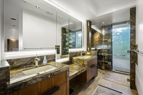 a kitchen with granite countertop a sink stove and refrigerator