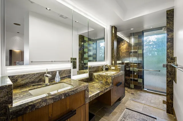 a kitchen with granite countertop a sink stove and refrigerator