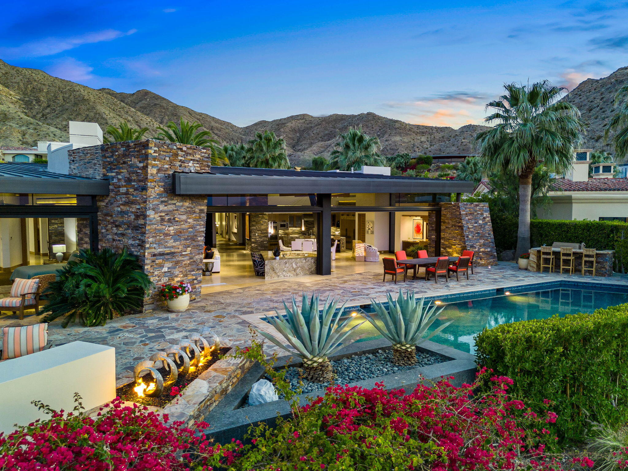 55 Granite Ridge Road Rancho Mirage, CA 92270 - Photo 21 of 34 a view of swimming pool with outdoor seating and a garden