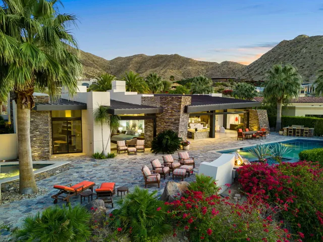 a view of a house with pool and sitting area