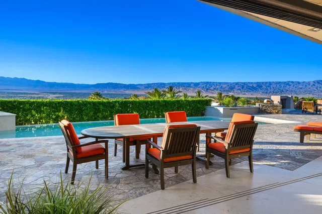 a roof deck with table and chairs