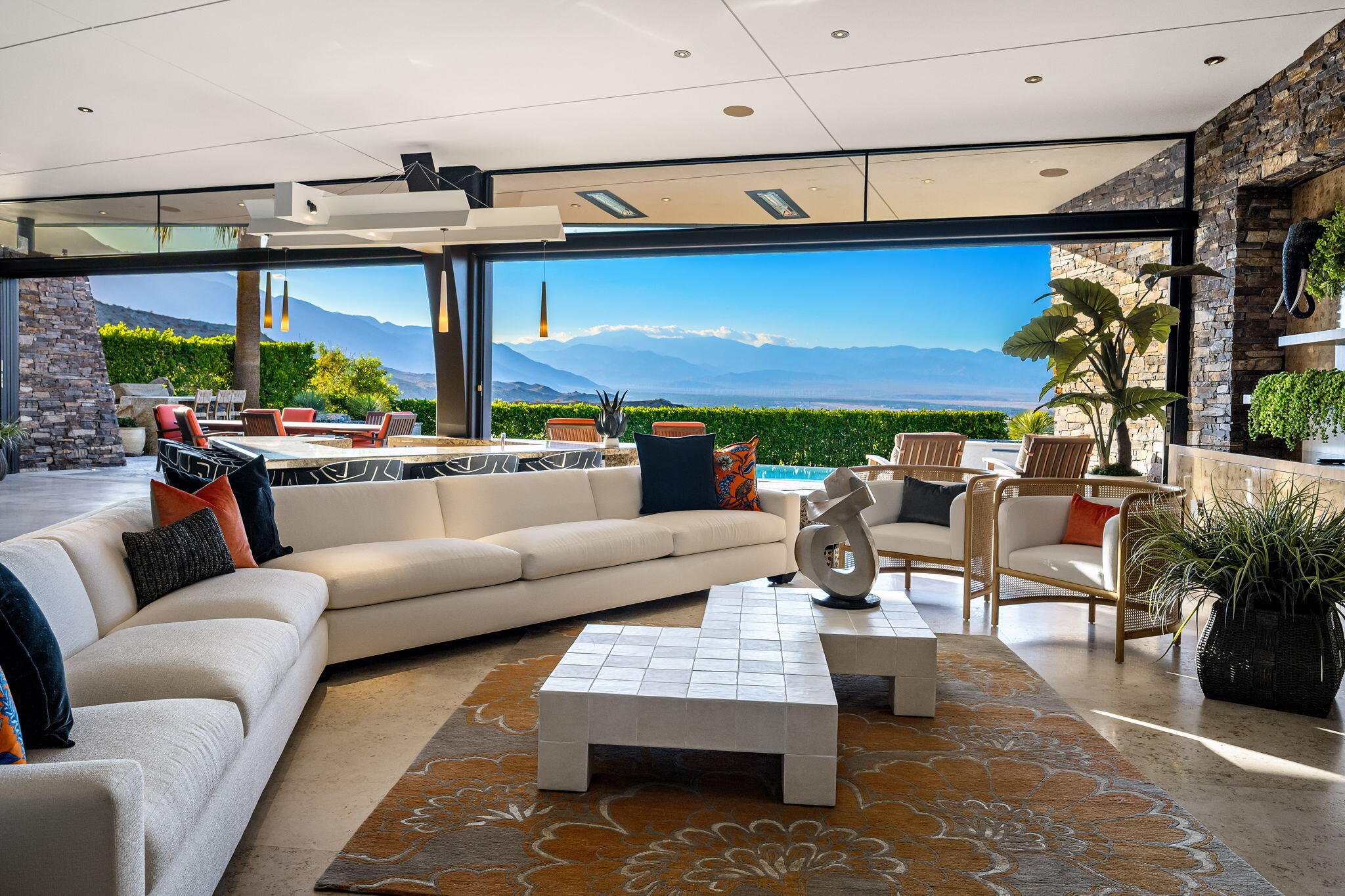 55 Granite Ridge Road Rancho Mirage, CA 92270 - Photo 4 of 34 a living room with patio furniture and a fireplace