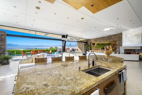 a kitchen with stainless steel appliances granite countertop a sink and a counter space