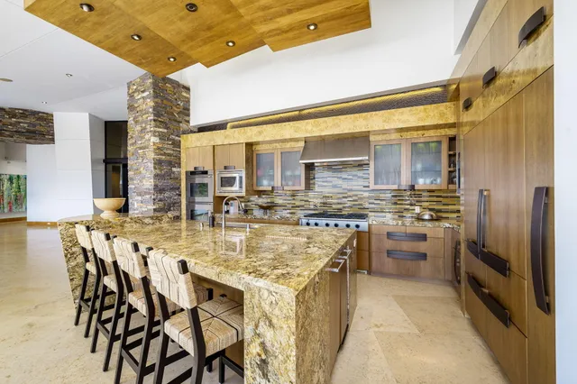 a kitchen with cabinets and chairs