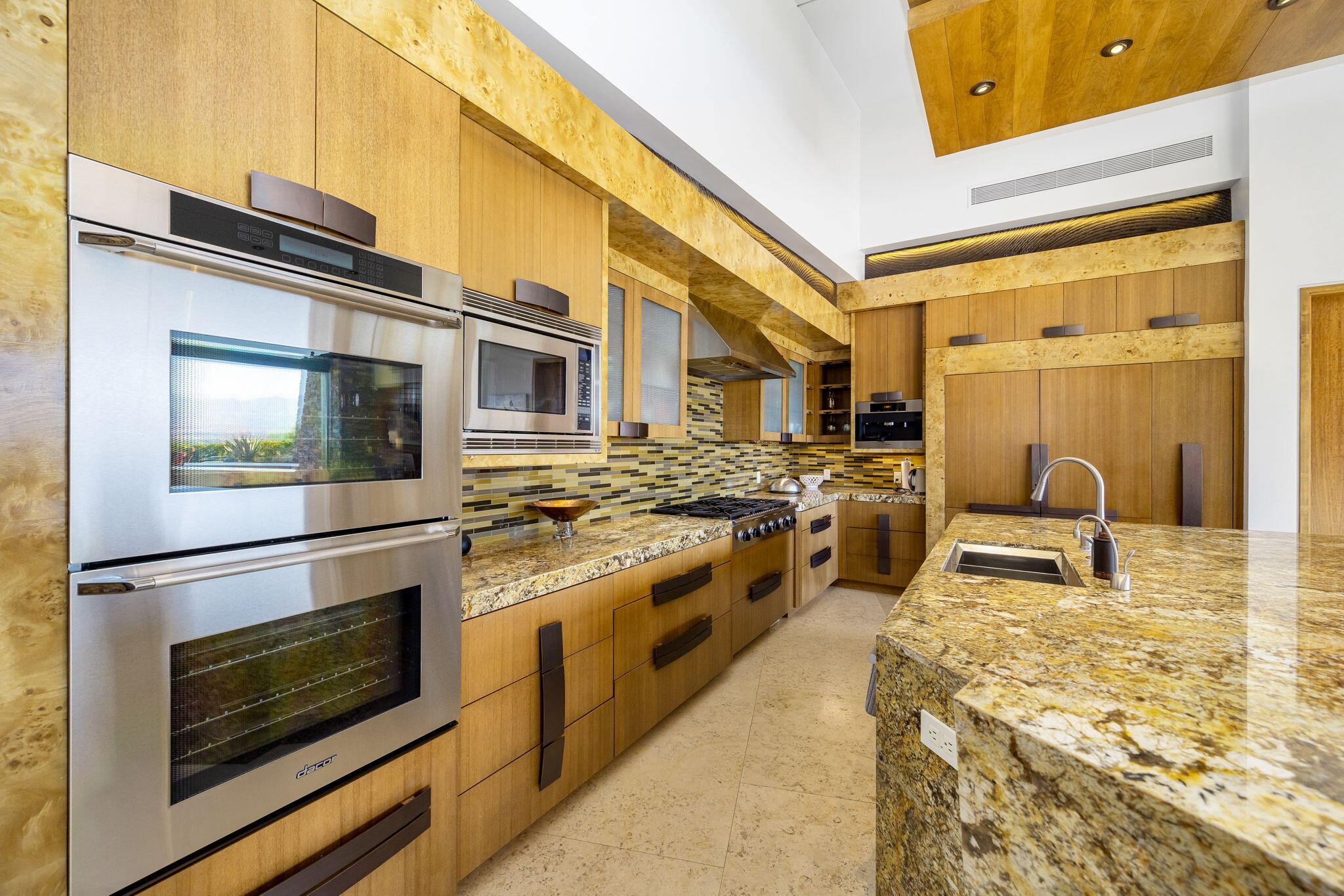 55 Granite Ridge Road Rancho Mirage, CA 92270 - Photo 10 of 34 a kitchen with stainless steel appliances granite countertop a stove a sink and a microwave