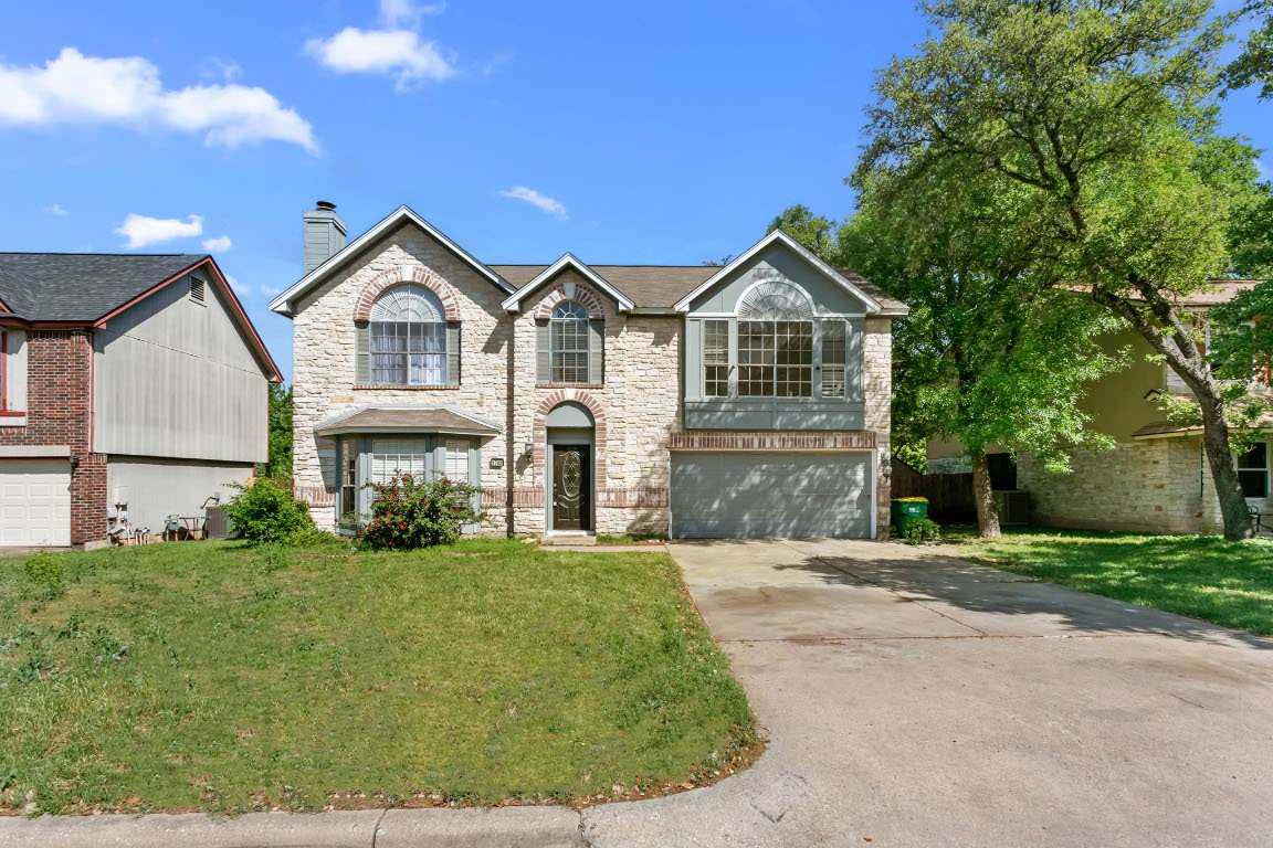 a front view of a house with a yard