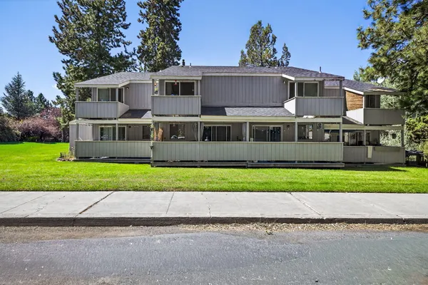 a front view of a house with a garden and yard