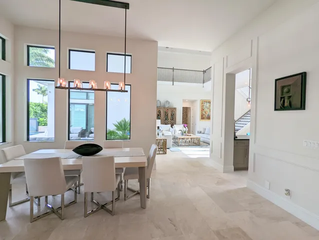 a kitchen with stainless steel appliances kitchen island granite countertop a sink a stove and refrigerator