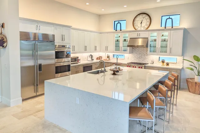 a kitchen with a stove a microwave and cabinets