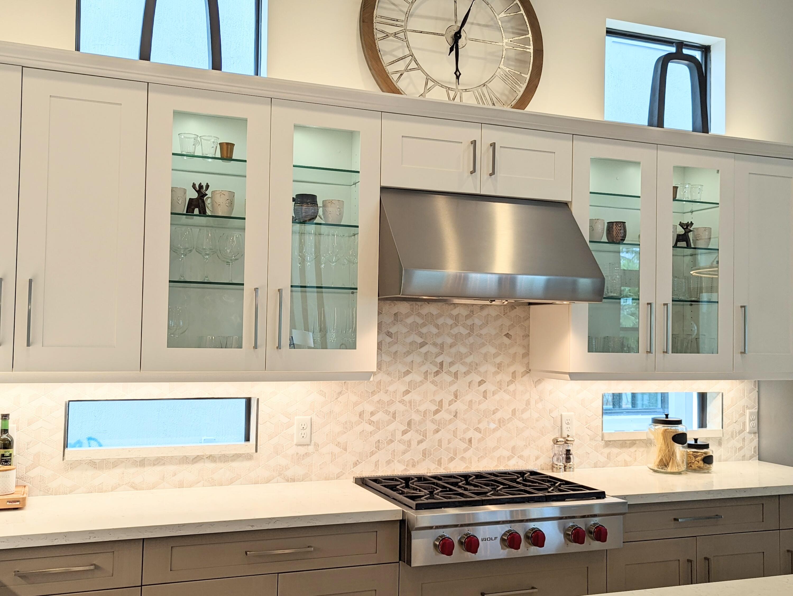 7095 Northwest 27th Avenue Boca Raton, FL 33496 - Photo 14 of 51 a kitchen with a stove a microwave and cabinets