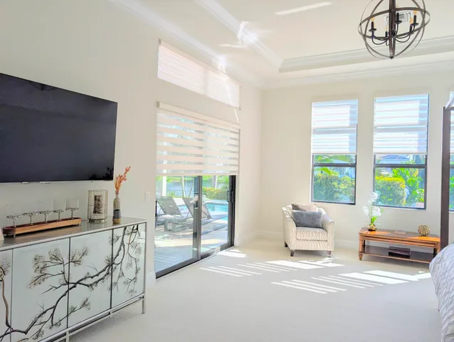 a living room with furniture and a floor to ceiling window